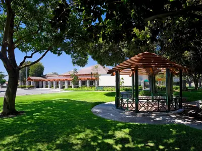 Senior Center in distance with gazebo and shaded trees in foreground